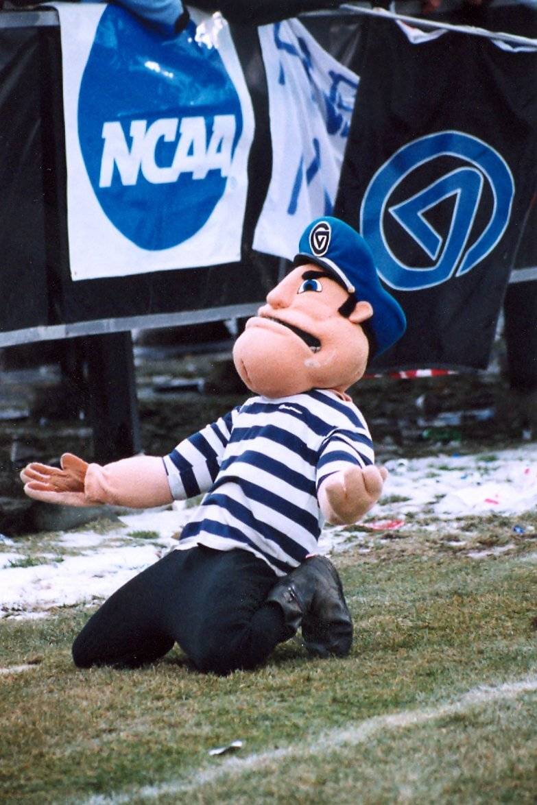 Louie posing at a football game on his knees